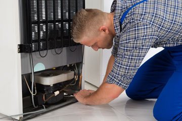 Man Repairing Fridge