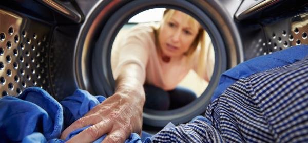 Woman Reaching into Washer